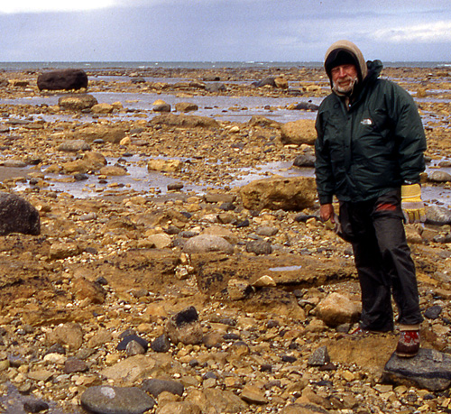 Ed Dobrzanski braves the weather on a boulder shore
