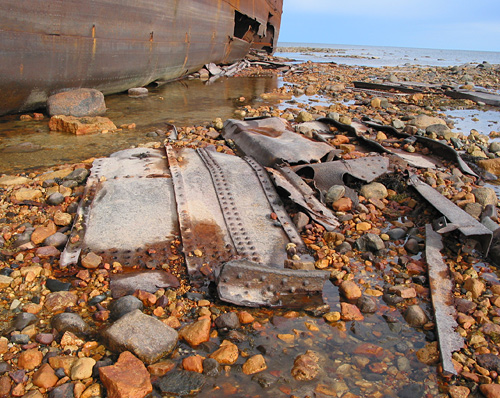 The ship was long ago stripped of its cargo and any valuables, and has been left to gently rust and decay on the tidal flat.