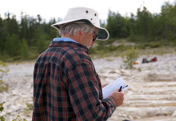 A scruffy paleontologist fills in his field notebook.  The two shirts are not some sort of ill-planned fashion statement; I was cold that day! (photo © Michael Cuggy)