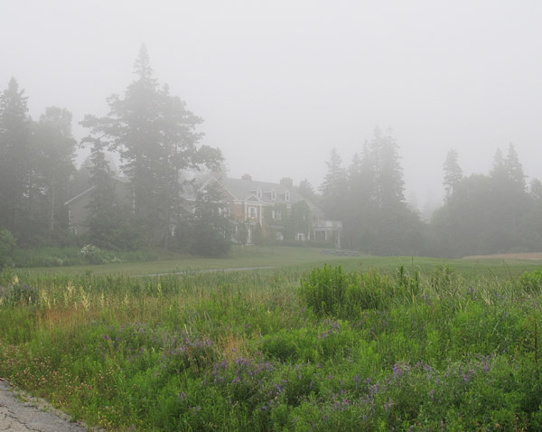 Anderson House, a former mansion converted into residence and dining hall by the Huntsman, is glimpsed through the evening fog