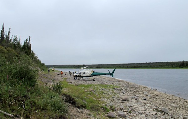 Helicopters and the field party visiting one of the riverbank outcrops