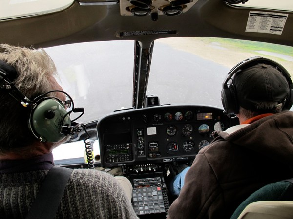 For the return flight, Brian takes the seat beside Robert.