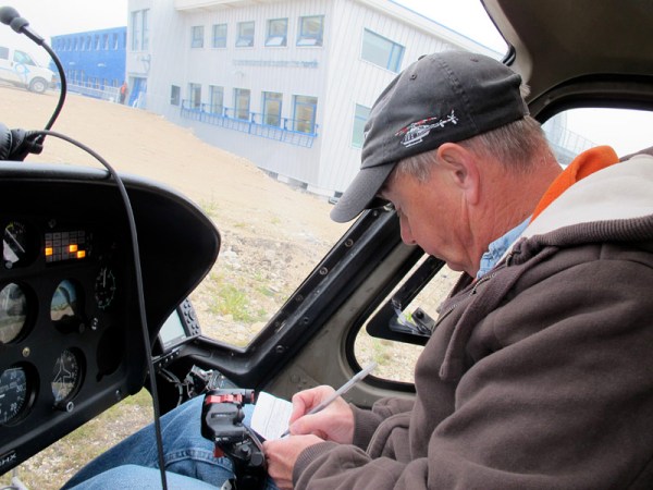 Robert, our pilot, fills in his logbook