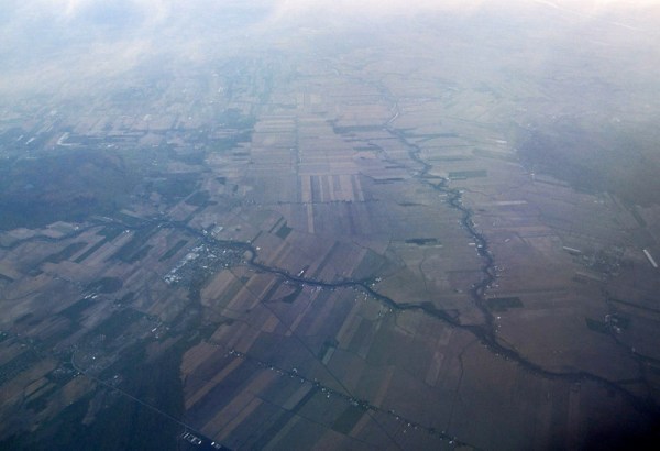 The sediment of the Lowland plain is cut by rivers. Note the characteristic Québec field pattern, with long narrow fields extending away from the waterways.